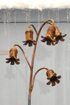 Rusty metal Bluebells sculpture on a winter's day with icicles in the background