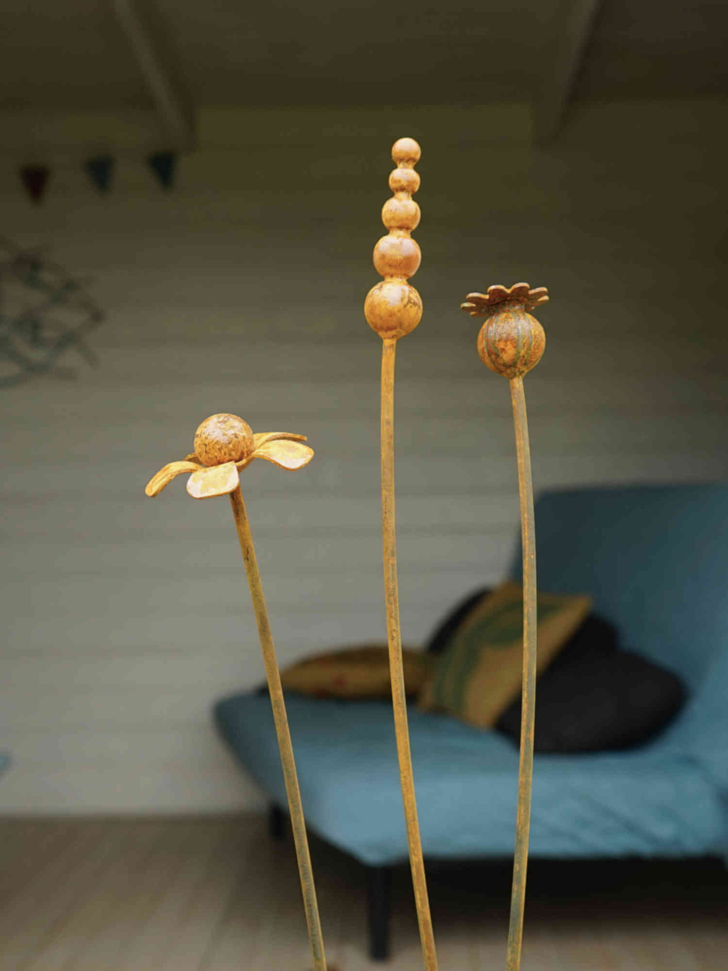 Rusty metal mixed flowers sculptures with a blurred background